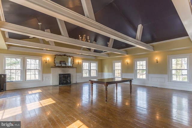 game room featuring crown molding, a fireplace, wood-type flooring, and vaulted ceiling