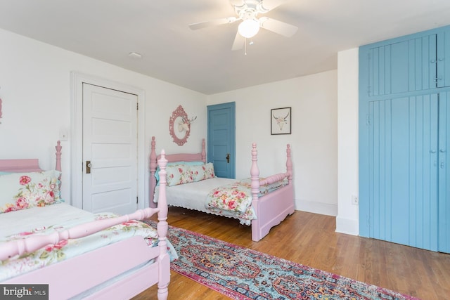 bedroom with ceiling fan and light hardwood / wood-style floors