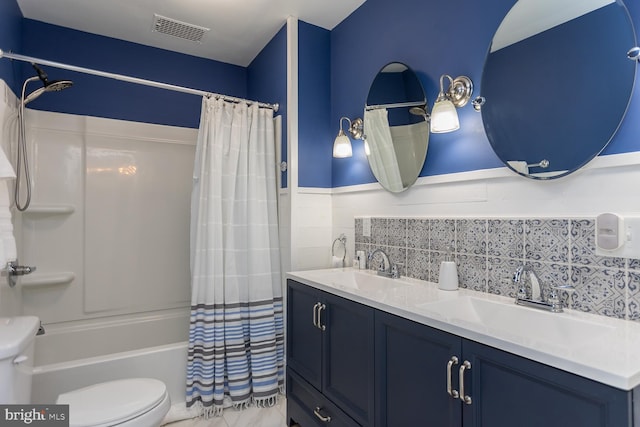 full bathroom featuring shower / bath combination with curtain, vanity, and toilet