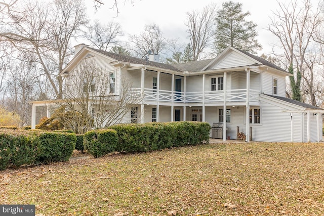 view of front of property with a front yard and a hot tub