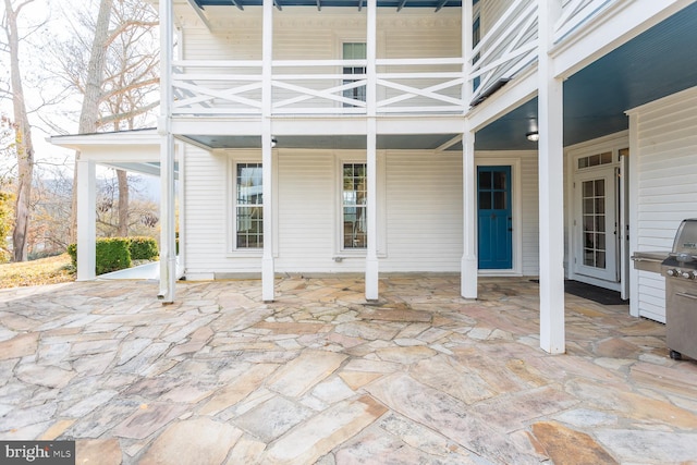 view of patio featuring a balcony