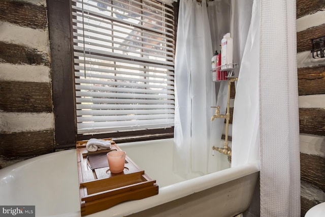 bathroom with shower / tub combo with curtain