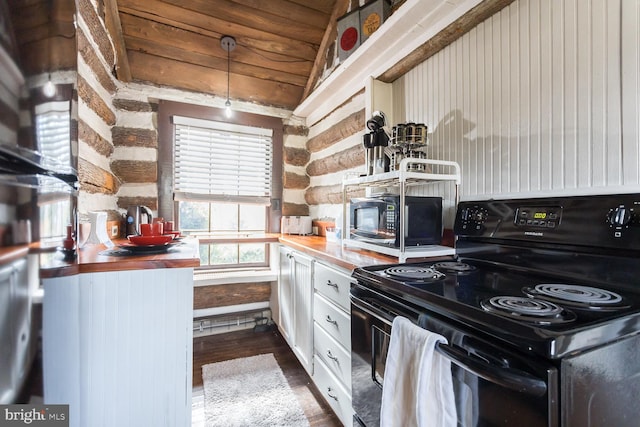 kitchen with pendant lighting, dark wood-type flooring, wooden counters, black / electric stove, and wood ceiling