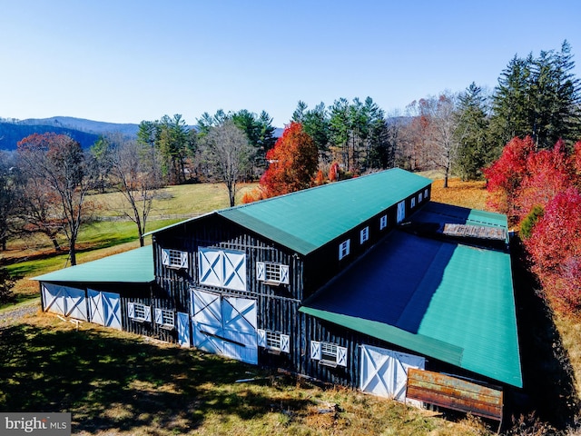 back of property with a mountain view