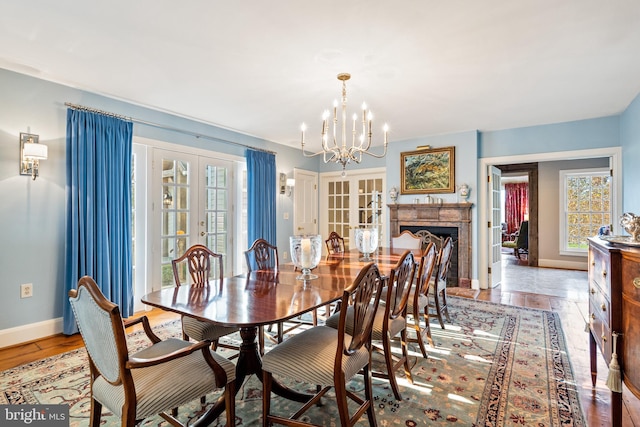 dining space with french doors and a chandelier