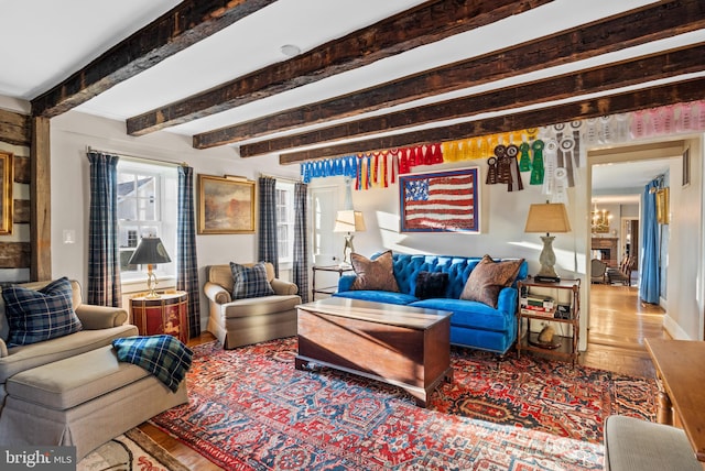 living room with hardwood / wood-style flooring and beam ceiling