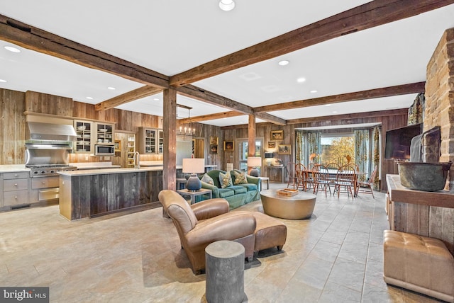 living room featuring beam ceiling, wooden walls, and light tile floors