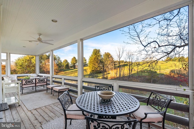 wooden terrace featuring ceiling fan and an outdoor hangout area