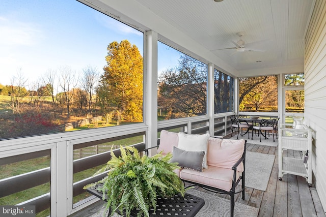 sunroom featuring ceiling fan