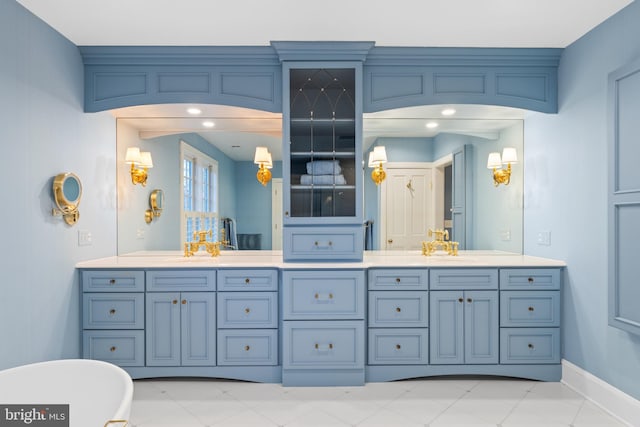 bathroom with large vanity, tile floors, and double sink