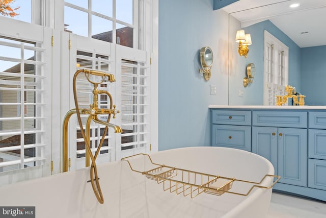 interior space with vanity, tile floors, and a bathtub