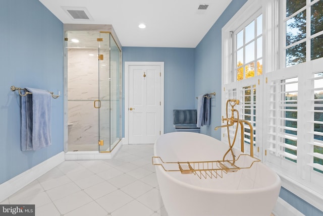 bathroom featuring separate shower and tub and tile floors