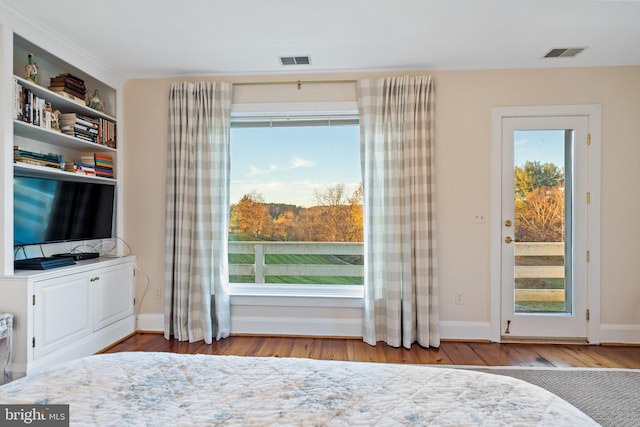 unfurnished bedroom featuring wood-type flooring and access to exterior