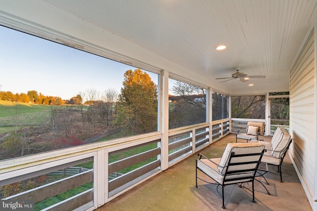 sunroom / solarium featuring ceiling fan