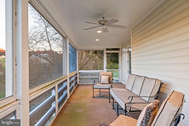 sunroom / solarium featuring ceiling fan