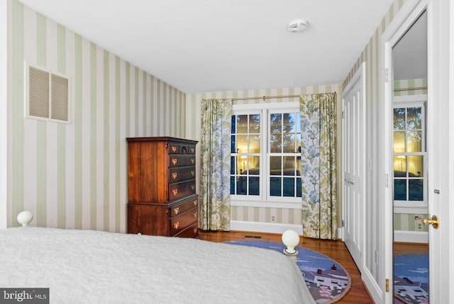 bedroom featuring hardwood / wood-style flooring and multiple windows