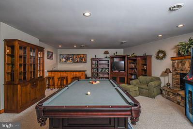 recreation room featuring carpet, pool table, and indoor bar