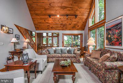 living room featuring light hardwood / wood-style floors, wooden ceiling, and high vaulted ceiling