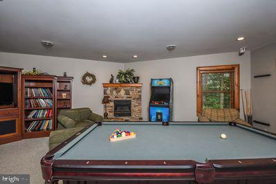 game room with a fireplace, carpet floors, and pool table