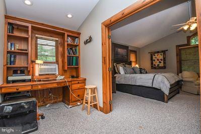 bedroom with ceiling fan, cooling unit, light colored carpet, and lofted ceiling