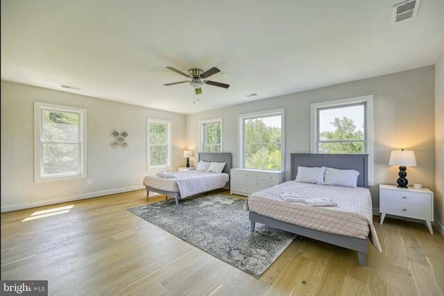 bedroom with ceiling fan and light hardwood / wood-style floors