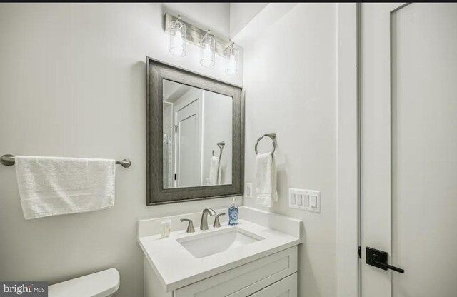 bathroom with toilet and vanity