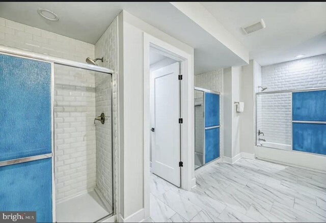 bathroom featuring combined bath / shower with glass door