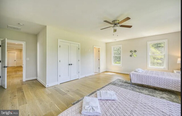 bedroom with light wood-type flooring and ceiling fan