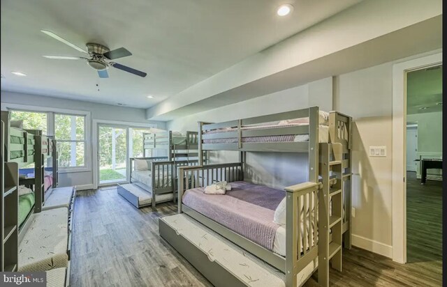 bedroom featuring ceiling fan, access to exterior, and hardwood / wood-style flooring