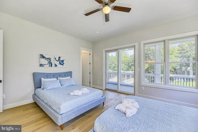 bedroom with light wood-type flooring, ceiling fan, access to outside, and multiple windows