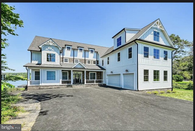 view of front of home with a garage and a porch