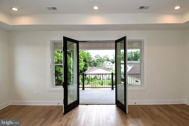 doorway to outside featuring hardwood / wood-style flooring, plenty of natural light, and french doors