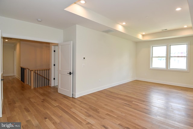 empty room with light hardwood / wood-style flooring