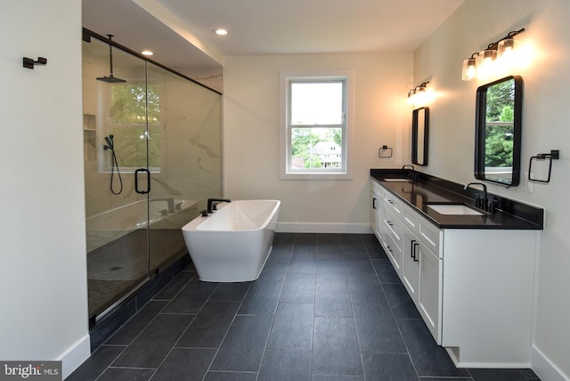 bathroom featuring shower with separate bathtub and vanity