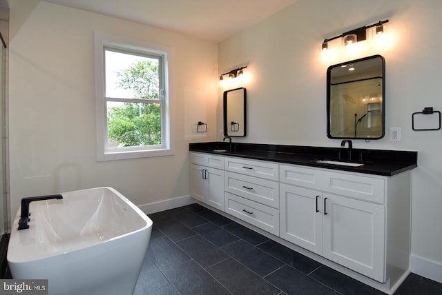 bathroom with tile patterned flooring, vanity, and a washtub