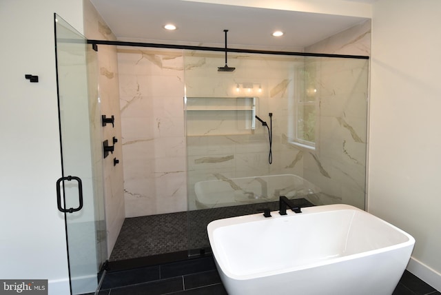 bathroom featuring tile patterned flooring and independent shower and bath