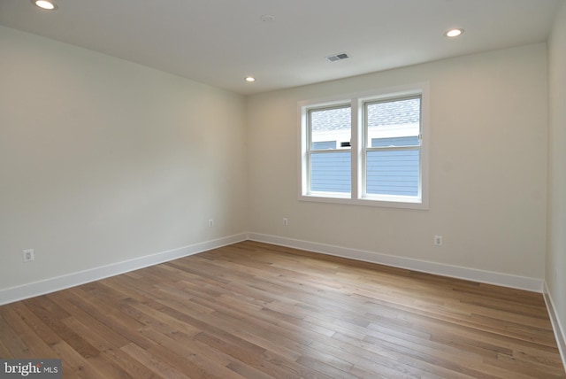 spare room with light hardwood / wood-style floors