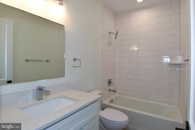 full bathroom with tiled shower / bath combo, toilet, and vanity