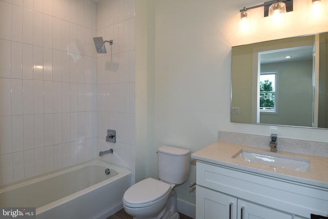 full bathroom featuring vanity, toilet, and tiled shower / bath