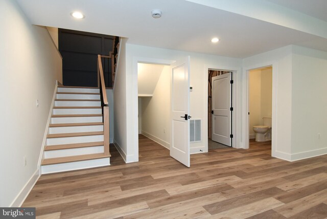 staircase with wood-type flooring