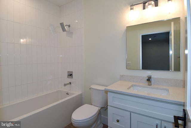 full bathroom with vanity, tiled shower / bath combo, and toilet