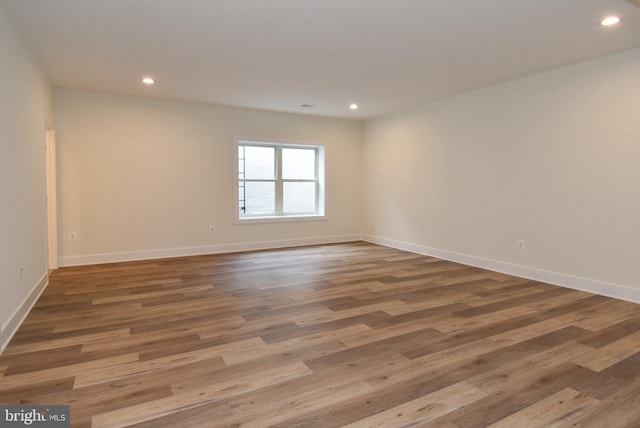 unfurnished room featuring hardwood / wood-style flooring