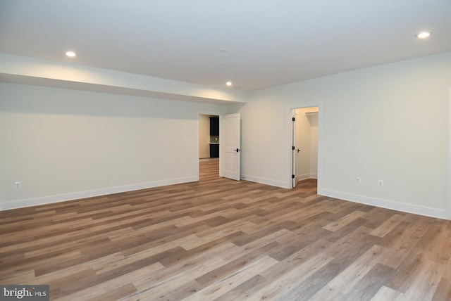 basement with light hardwood / wood-style flooring