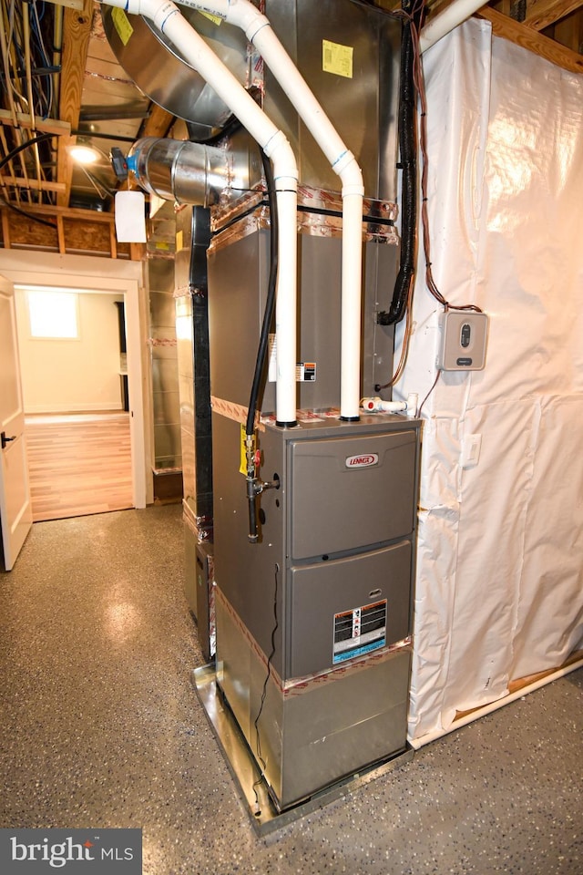 utility room featuring heating unit