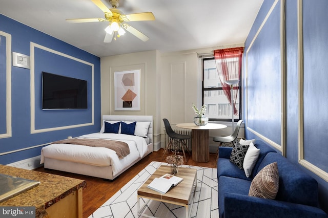 bedroom featuring wood-type flooring and ceiling fan