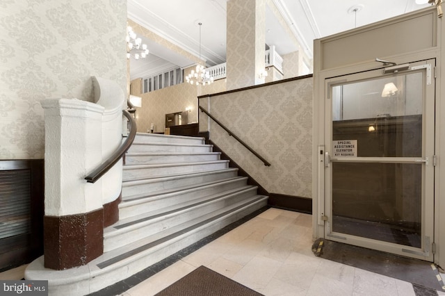 stairs featuring crown molding and a notable chandelier