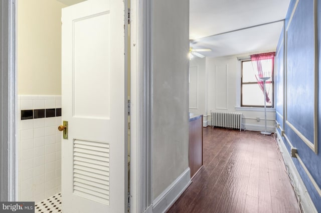 bathroom with radiator heating unit, wood-type flooring, and ceiling fan