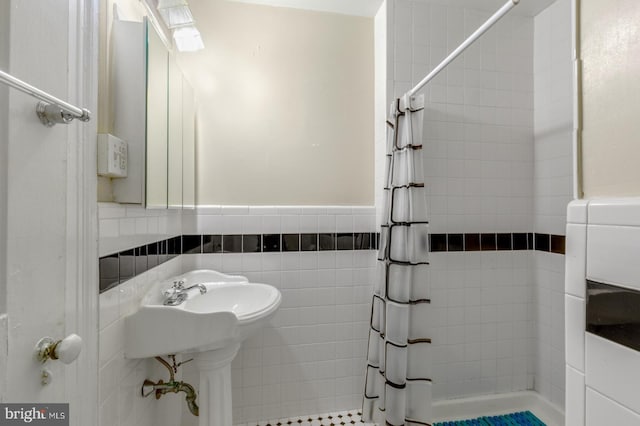 bathroom featuring tile walls and walk in shower