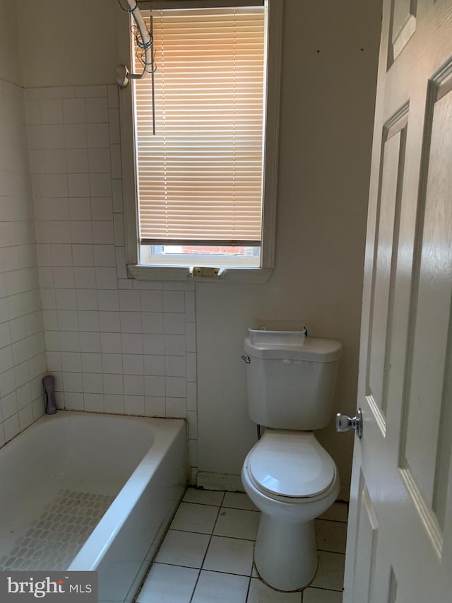 bathroom featuring tile floors and toilet