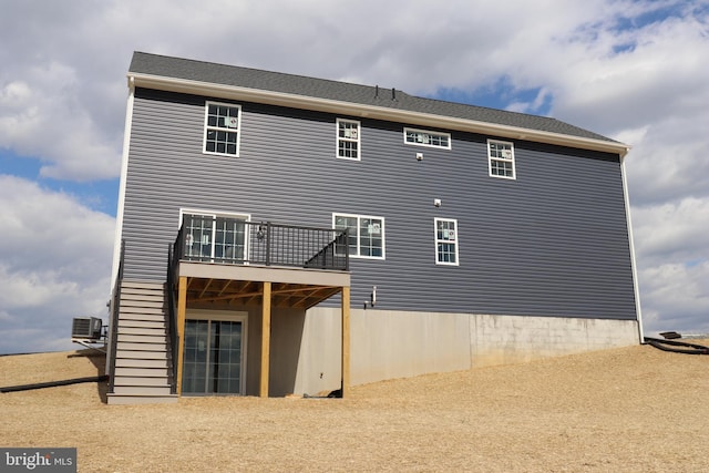 back of property featuring a balcony and central air condition unit